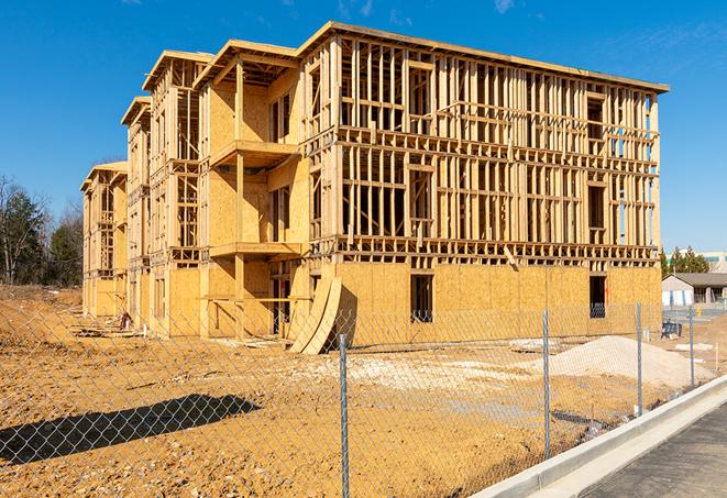 construction zone secured with a temporary fence, marked with warning signs in Oakley