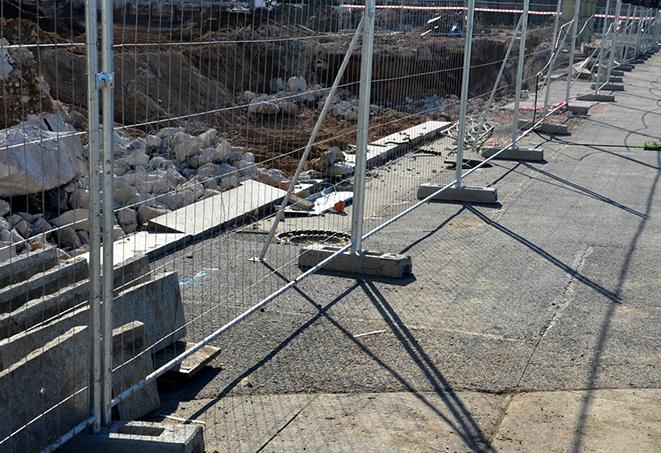 temporary fence panels used to create a barrier at a public event for safety purposes